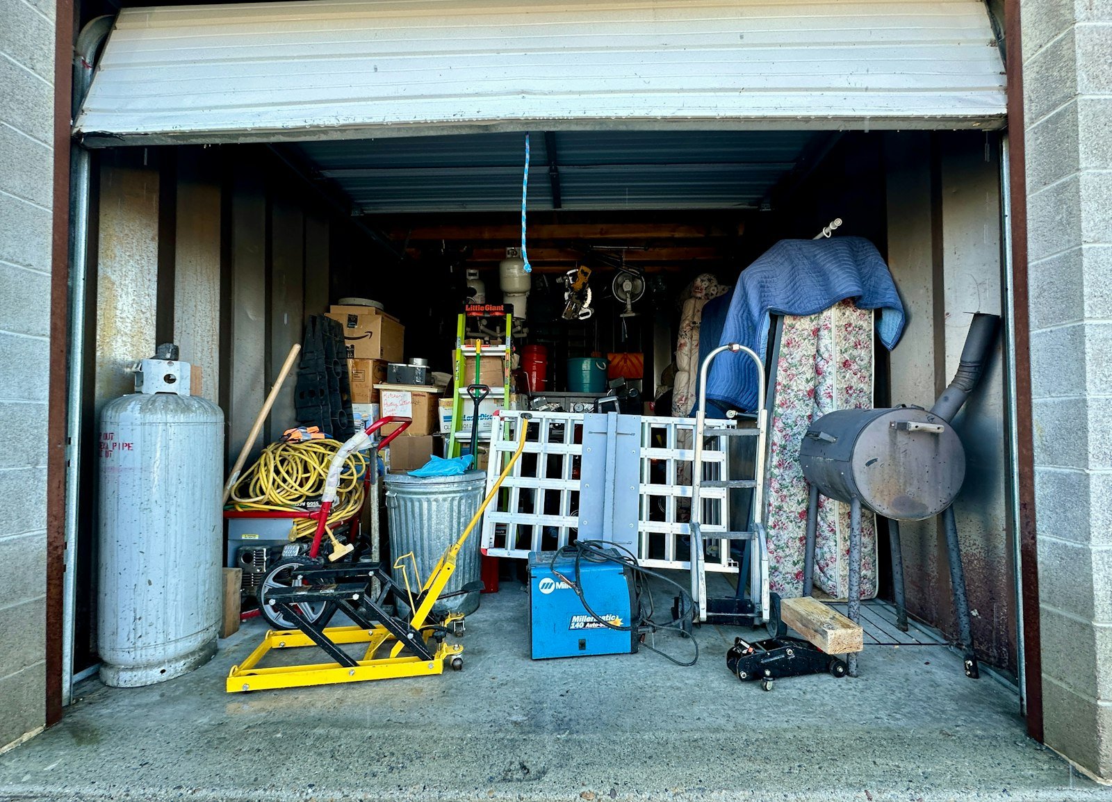 Old furniture and junk stacked ready for rubbish clearance